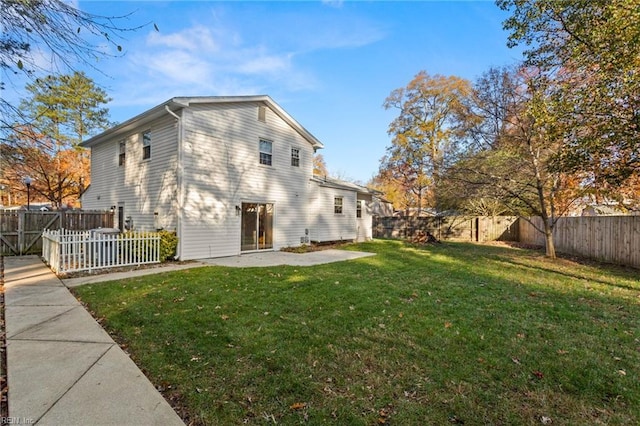 back of property featuring a patio area, a lawn, and a fenced backyard