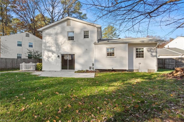 back of house featuring a patio area, a lawn, and a fenced backyard