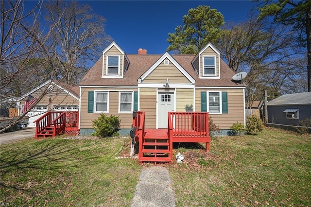 new england style home with a deck, a front lawn, and roof with shingles