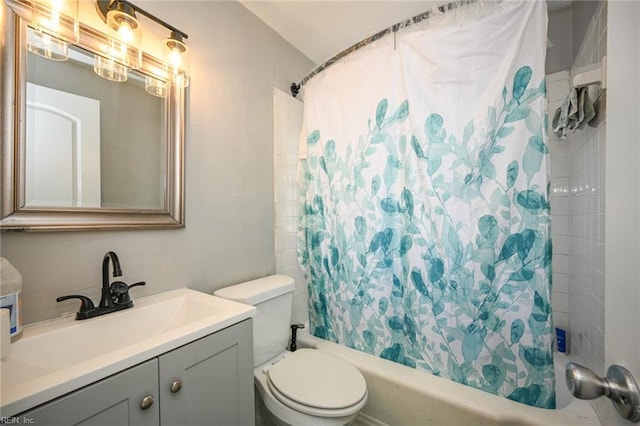 bathroom featuring vanity, toilet, and shower / bath combo