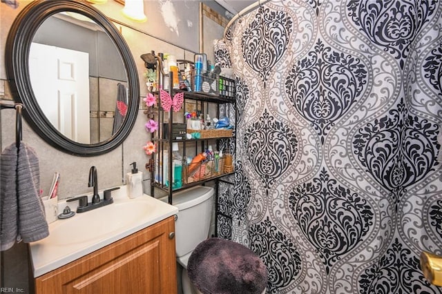 bathroom with toilet and vanity