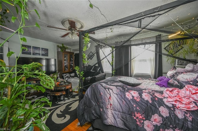 bedroom with a textured ceiling and wood finished floors