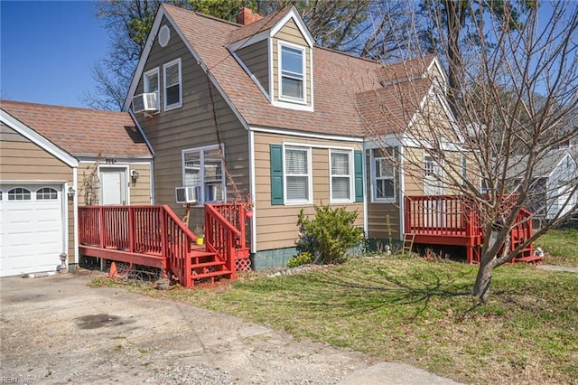 view of front of house with an attached garage, a shingled roof, driveway, and a front lawn