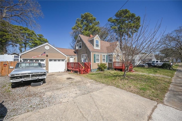 cape cod home with fence, driveway, a wooden deck, a front lawn, and a garage