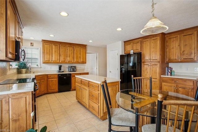 kitchen featuring brown cabinets, black appliances, recessed lighting, light countertops, and light tile patterned floors