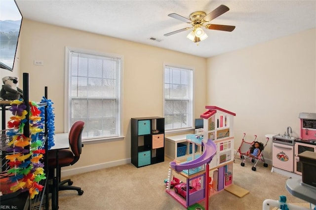 game room with visible vents, a ceiling fan, baseboards, and carpet floors