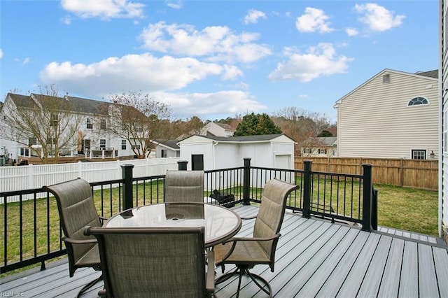 deck with a residential view, a lawn, outdoor dining area, and a fenced backyard