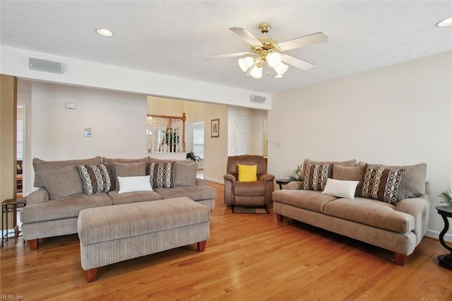 living area with visible vents, light wood finished floors, and ceiling fan