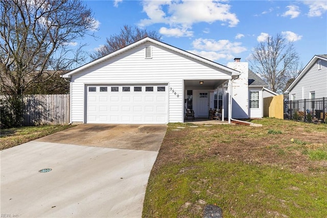 view of front of home featuring concrete driveway, fence, and a garage