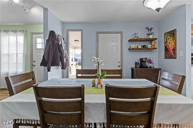 dining space with wood finished floors