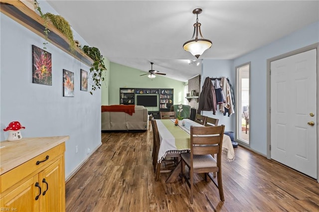 dining space featuring baseboards, dark wood-type flooring, and lofted ceiling