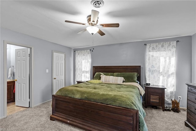 bedroom featuring visible vents, connected bathroom, carpet flooring, baseboards, and ceiling fan