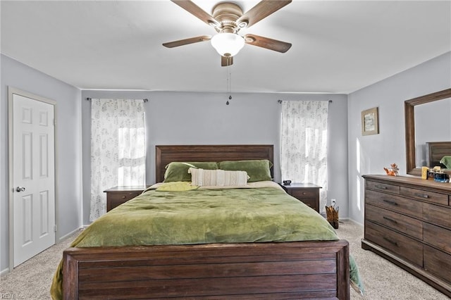 bedroom with light carpet, a ceiling fan, and baseboards