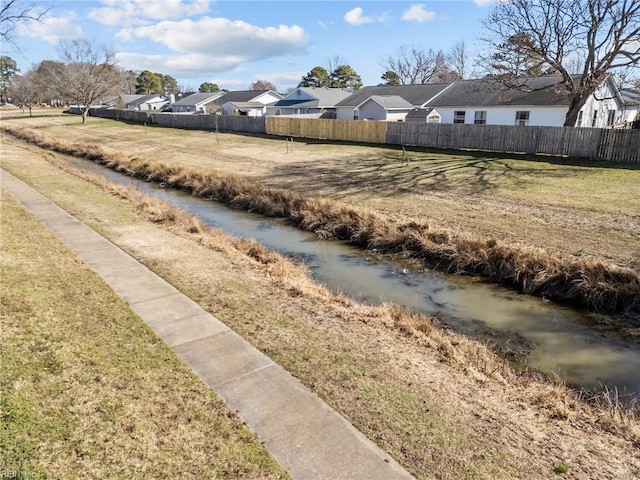 view of yard featuring fence and a residential view