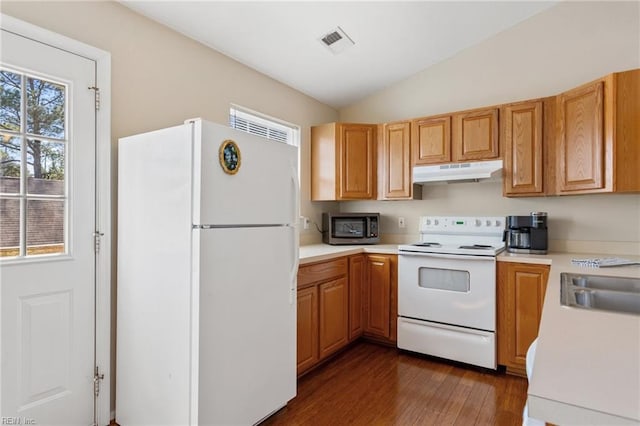 kitchen with white appliances, dark wood-style floors, lofted ceiling, light countertops, and under cabinet range hood