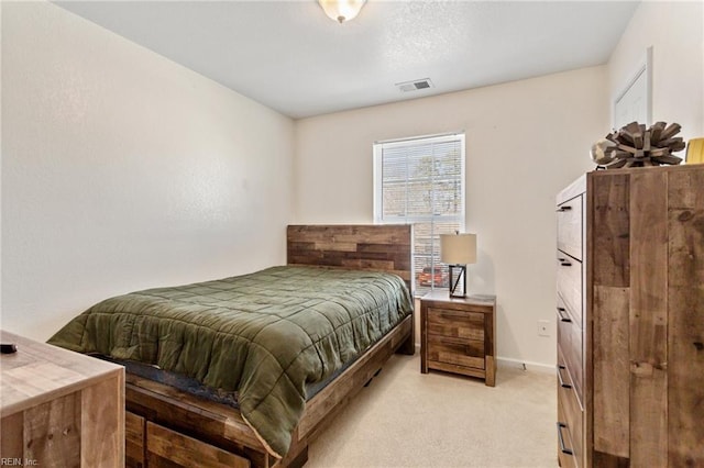 bedroom with baseboards, visible vents, and light carpet