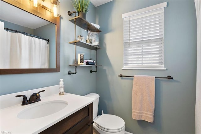 bathroom featuring toilet and vanity