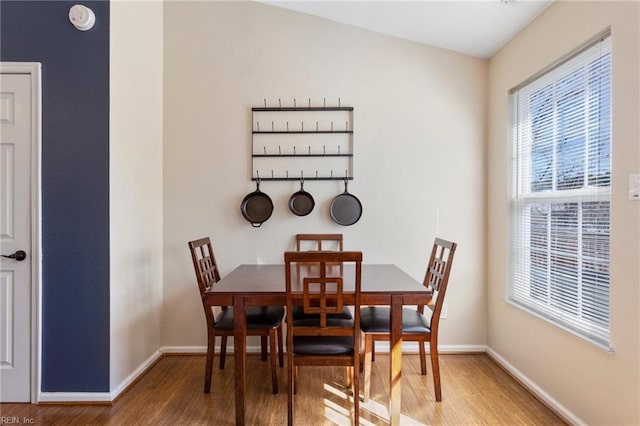 dining room with baseboards and wood finished floors