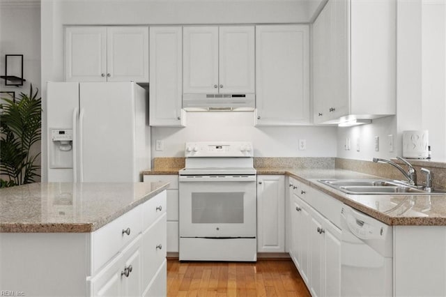 kitchen with light wood finished floors, under cabinet range hood, white appliances, white cabinetry, and a sink