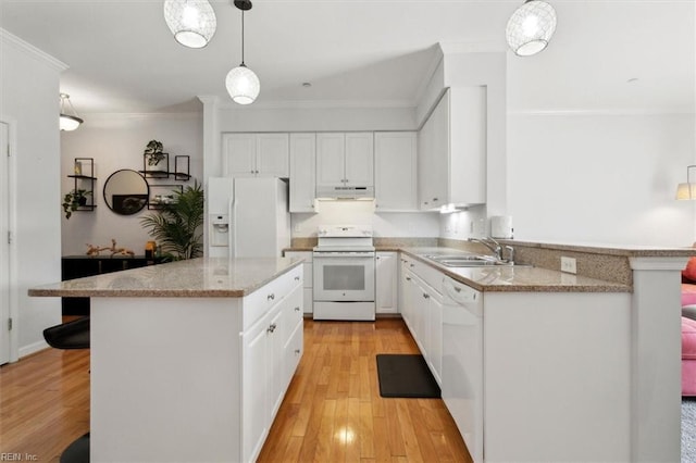 kitchen with ornamental molding, under cabinet range hood, a sink, white appliances, and light wood finished floors