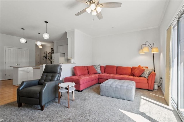 living room with light wood-type flooring and a ceiling fan