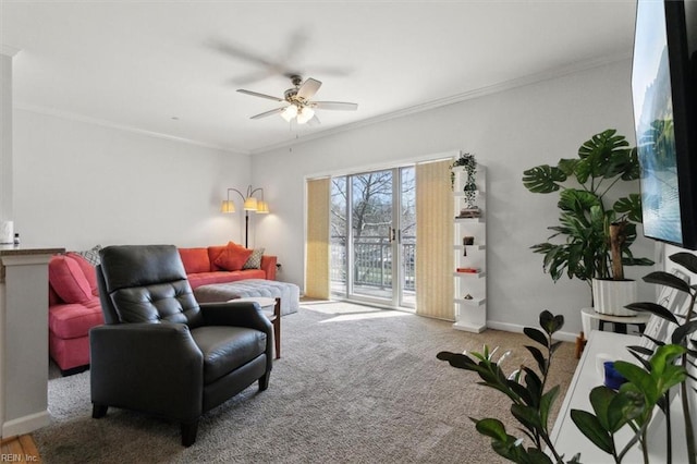 living room with carpet flooring, baseboards, a ceiling fan, and ornamental molding