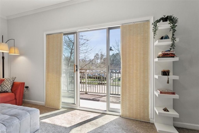 doorway to outside with plenty of natural light, carpet floors, and ornamental molding