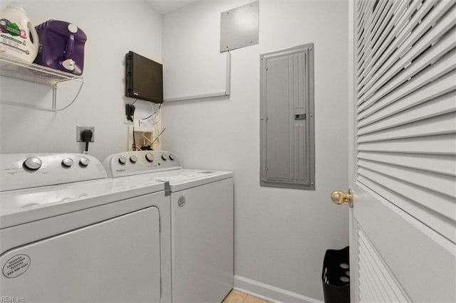 washroom featuring washer and dryer, laundry area, electric panel, and baseboards