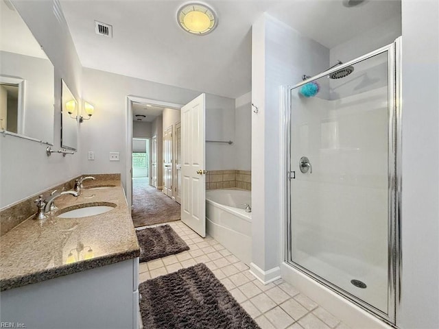 bathroom with visible vents, tile patterned floors, a stall shower, a bath, and a sink