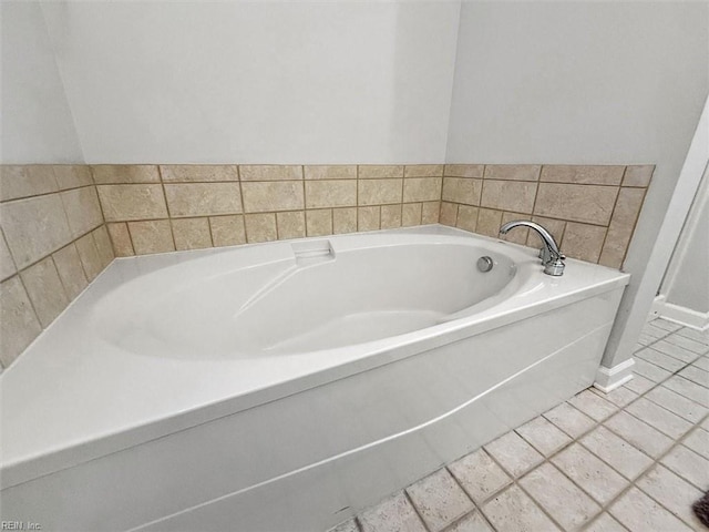 full bathroom with tile patterned floors and a bath