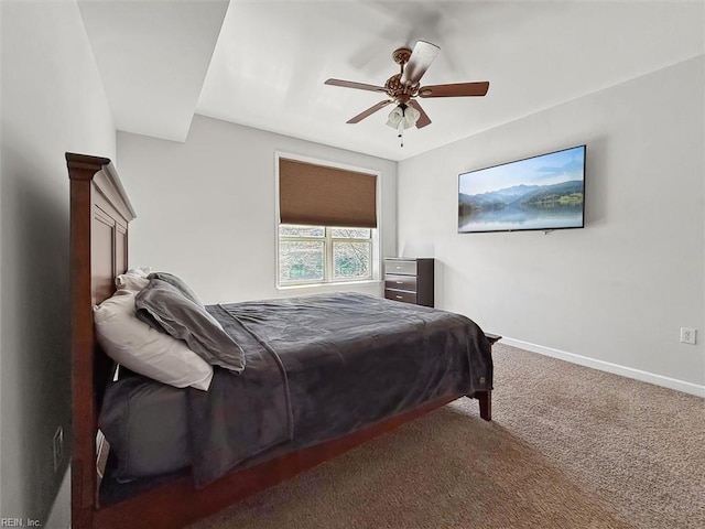 bedroom with a ceiling fan, baseboards, and carpet floors