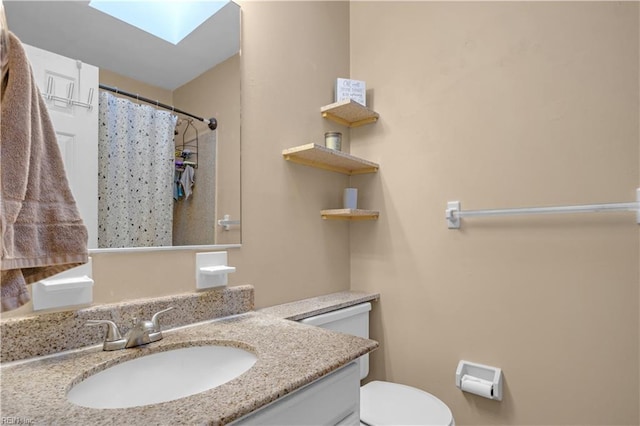 full bath featuring vanity, a skylight, toilet, and a shower with curtain