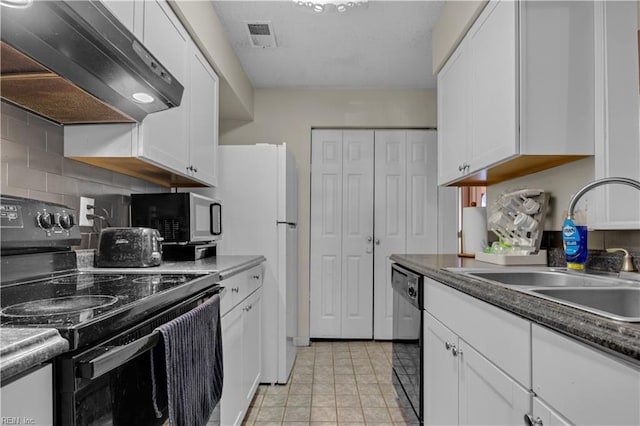 kitchen with visible vents, black appliances, a sink, wall chimney exhaust hood, and white cabinets