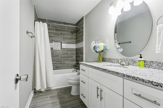 bathroom with vanity, wood tiled floor, shower / bath combination with curtain, a textured ceiling, and toilet