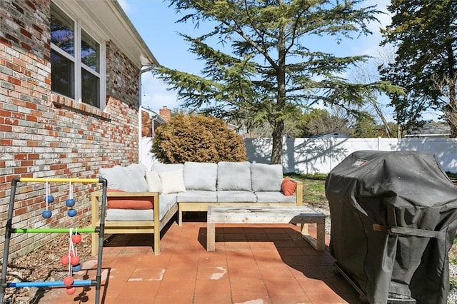 view of patio with area for grilling, a fenced backyard, and outdoor lounge area