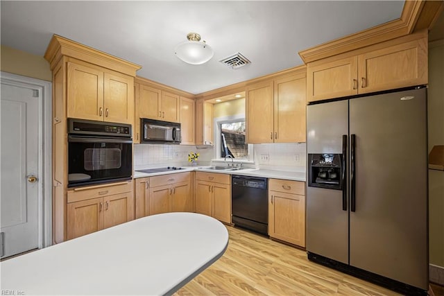 kitchen featuring visible vents, backsplash, light brown cabinetry, light countertops, and black appliances