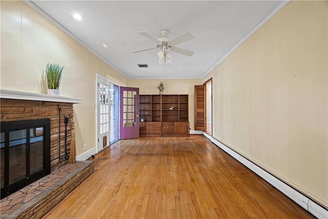 unfurnished living room with a ceiling fan, visible vents, hardwood / wood-style flooring, a baseboard heating unit, and crown molding