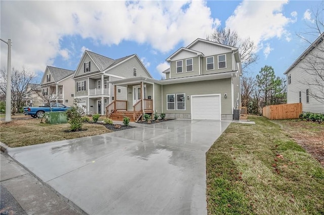 view of front of property featuring a garage, board and batten siding, concrete driveway, and fence