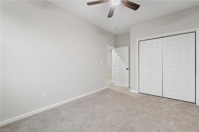 unfurnished bedroom featuring carpet flooring, baseboards, a closet, and ceiling fan