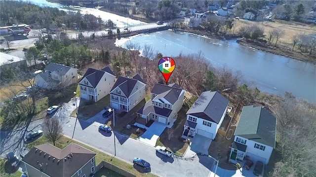 birds eye view of property with a residential view and a water view