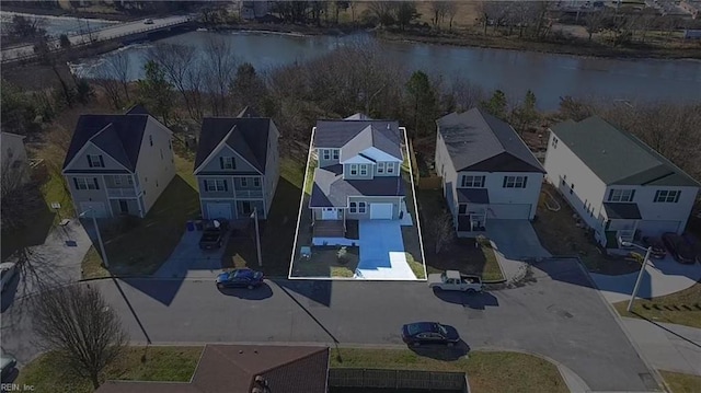 drone / aerial view featuring a residential view and a water view