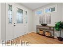 entryway with wood finished floors and a wealth of natural light