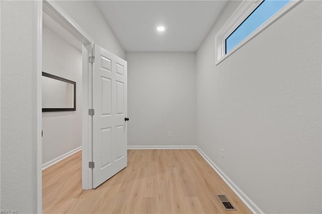 unfurnished room with baseboards, visible vents, and light wood finished floors