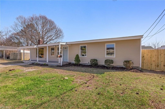 single story home with covered porch, a front yard, and fence