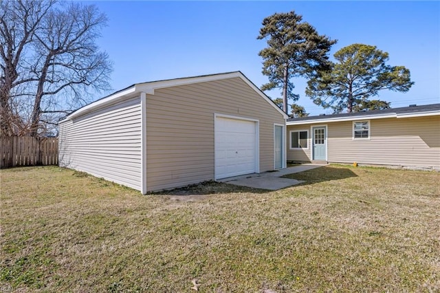 detached garage featuring fence