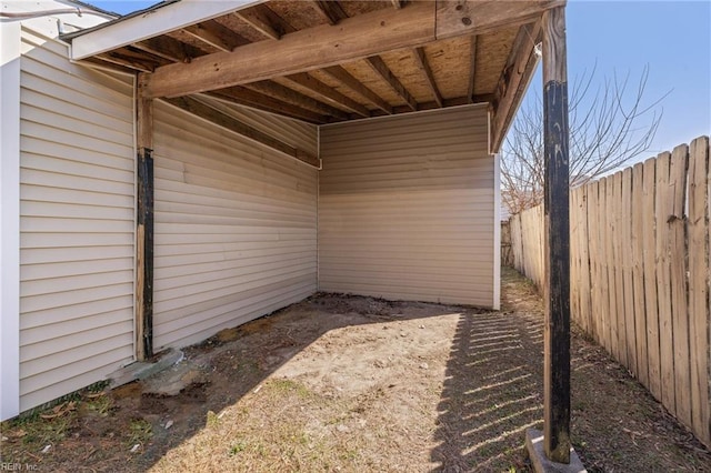 exterior space with a carport and fence