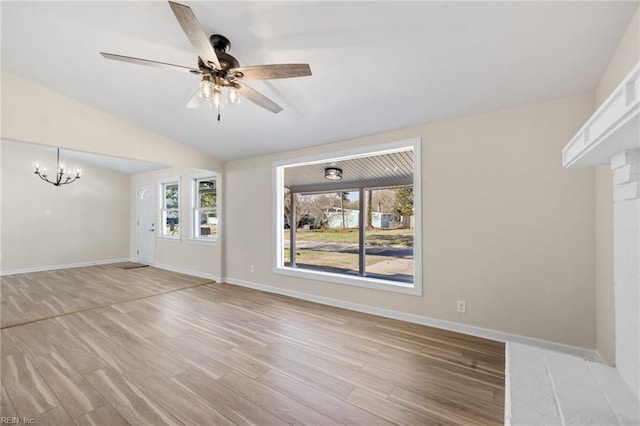 unfurnished living room featuring plenty of natural light, light wood-style floors, and baseboards