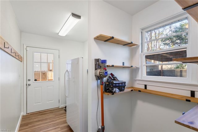 kitchen with baseboards and wood finished floors