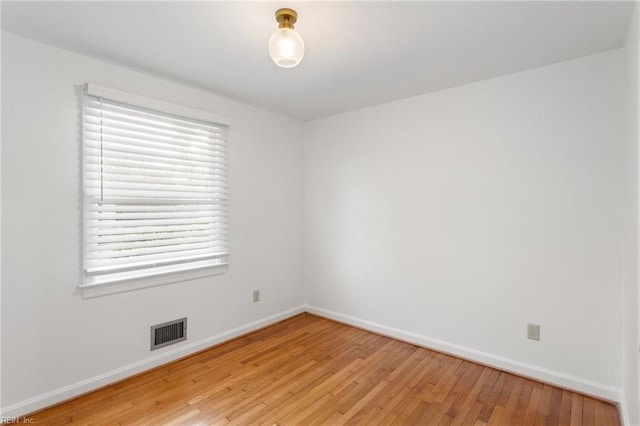 unfurnished room with visible vents, baseboards, and light wood-style floors