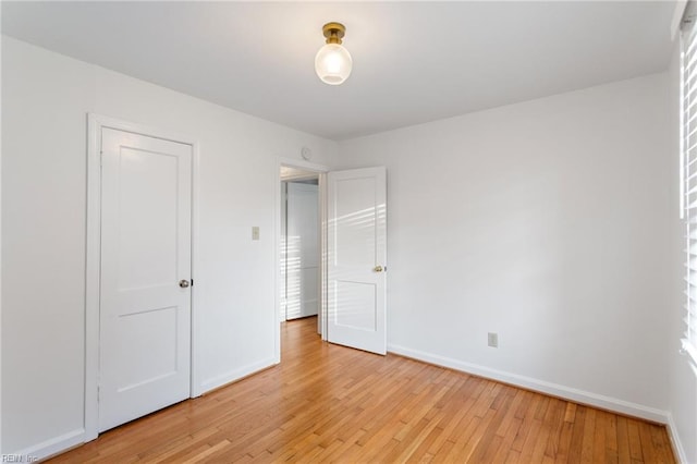 unfurnished bedroom featuring light wood-style flooring and baseboards